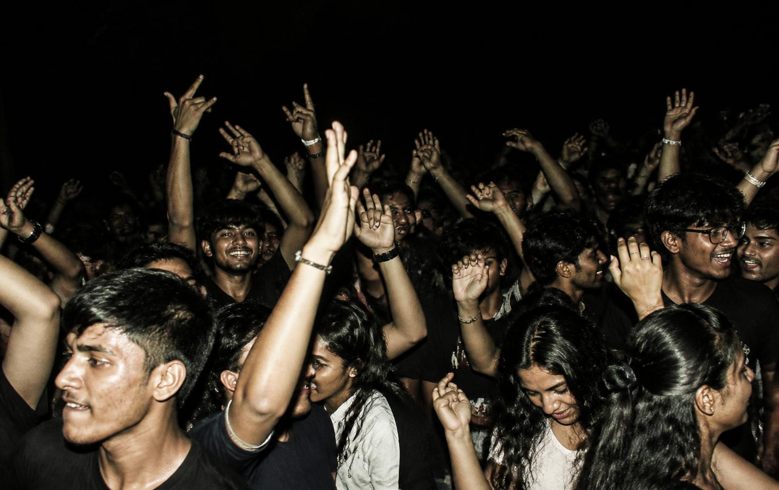 Students with their hands up at a college fest